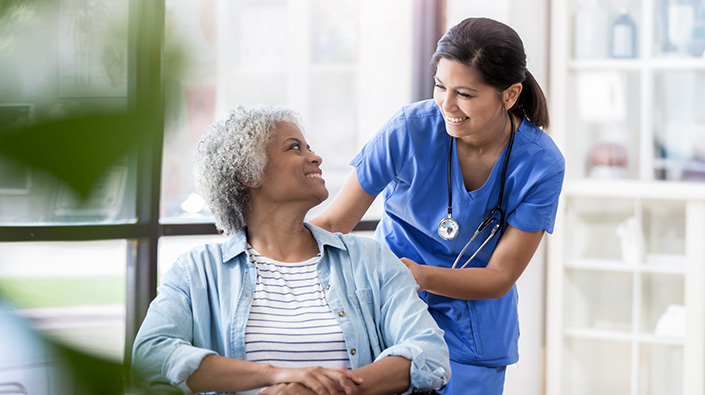 Nurse caring for mature patient 