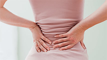 patient covering their painful back with their hands