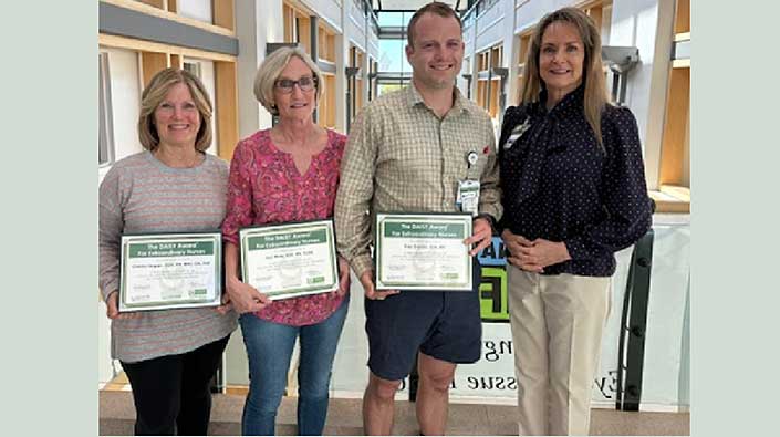 four nurses smiling with their awards