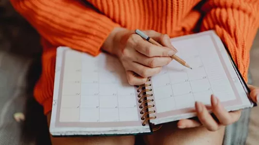 girl writing in calendar